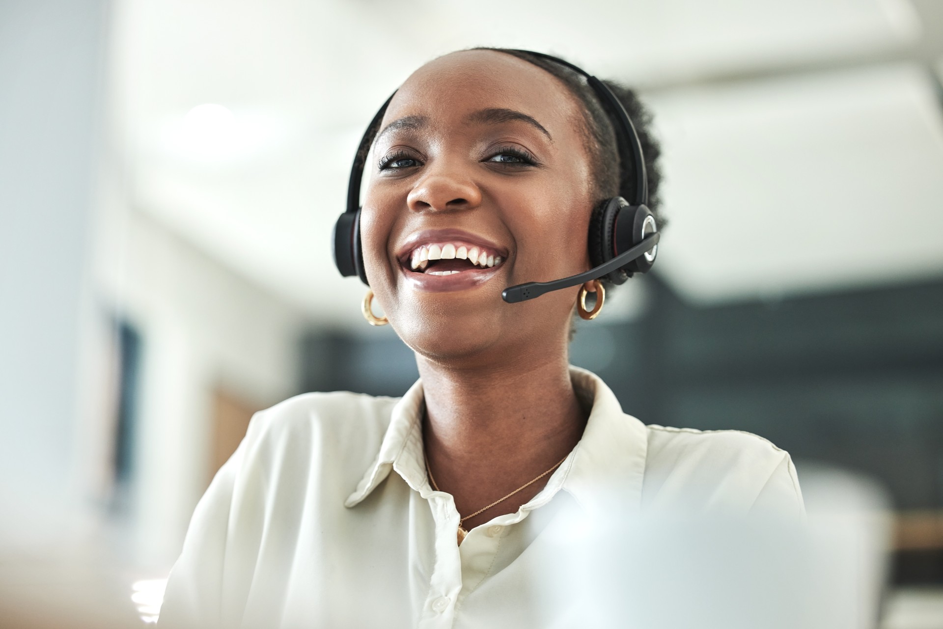 Shot of an attractive young call centre agent sitting alone in the office